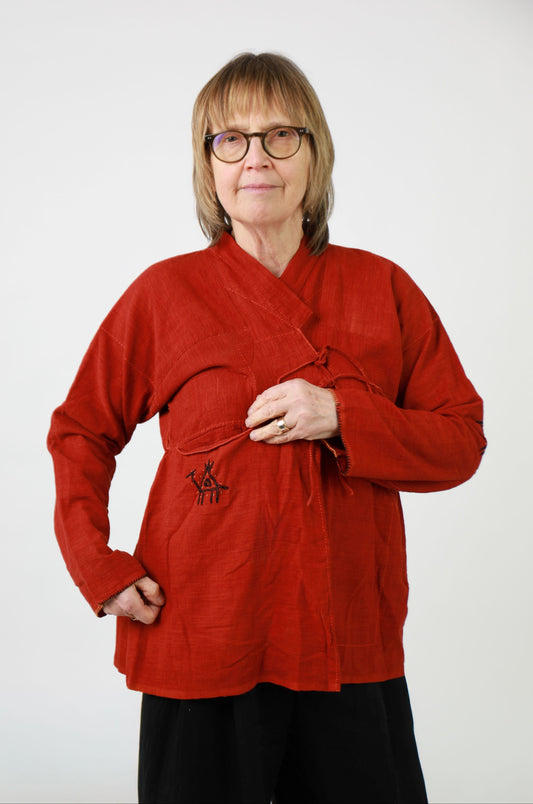 Person wearing a red top with a white background
